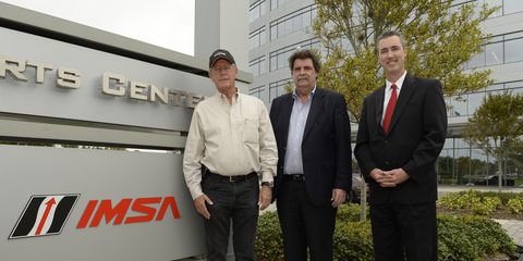 Jim France, Ed Bennett, and Mike Helton unveil the new IMSA sign at International Motorsports Center in Daytona Beach in November 2013.