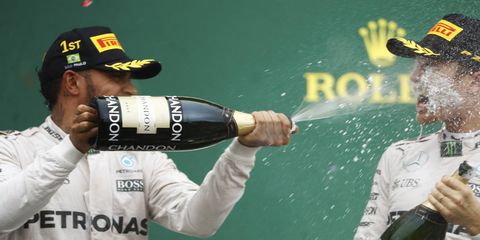 Lewis Hamilton sprays champagne over teammate Nico Rosberg on the podium Sunday.