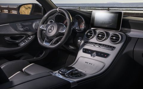 The central touchpad is flanked by the AMG Dynamic Select switch and several AMG-specific controls such as the button for the three-stage AMG Ride Control suspension, three-stage ESP or optionally the button for the AMG Performance Exhaust System.