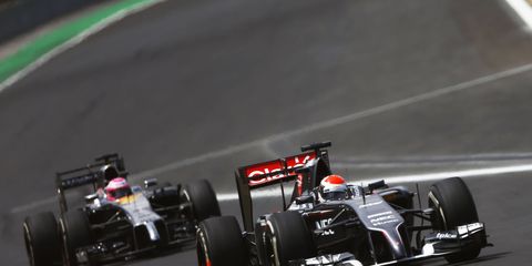 Sauber driver Adrian Sutil leading Jenson Button at the Brazilian Grand Prix.