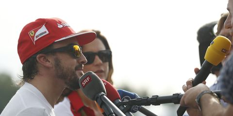 Fernando Alonso, left, appears headed for McLaren-Honda in 2015. McLaren-Honda boss Ron Dennis, however, said, not so fast on Saturday in Japan.