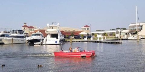 Swimming with the ducks, this Amphicar 770 is looking mighty fine boating by all those luxury yachts.