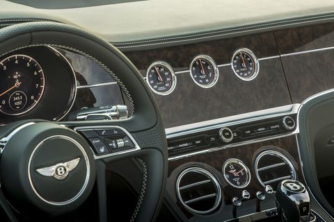 The 2019 Bentley Continental GT Convertible "Bentley Rotating Display" is a three-sided block where the owner can choose between 12.3-inch touchscreen or three analog gauges or, when the car isn't running, a simple block of veneer wood.