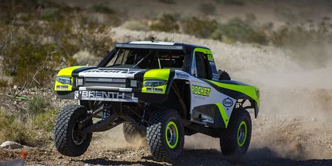 The Rocket Mototrsports Trophy Truck, driven by Jenson Button, among others, bashes its way through the desert during the last Mint 400. Those following the recent Mint 400 know that Jenson Button has formed a desert racing team that includes Chris Buncombe, former Aston Martin LMP driver, and Maz Fawaz, managing director for Singer Vehicle Design’s Dynamic and Lightweighting Study project. It’s been ten years since Jenson’s Formula One championship and he’s going to be celebrating that milestone with the very same livery on this team’s Trophy Truck, which they’re planning to use in the Baja 1000 later this year, as well as the Reno to Vegas rally in August.