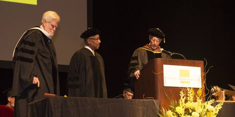 Board of trustees chair Keith Crain (left) and College for Creative Studies president Richard Rogers (right) present Ed Welburn an honorary Doctorate of Fine Arts.