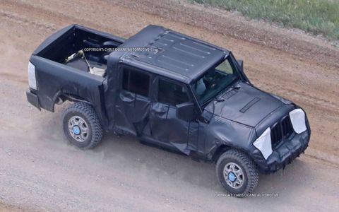 The 2019 Jeep Wrangler pickup is spotted for the first time, undergoing testing. Yes, that looks like a Ram pickup bed.