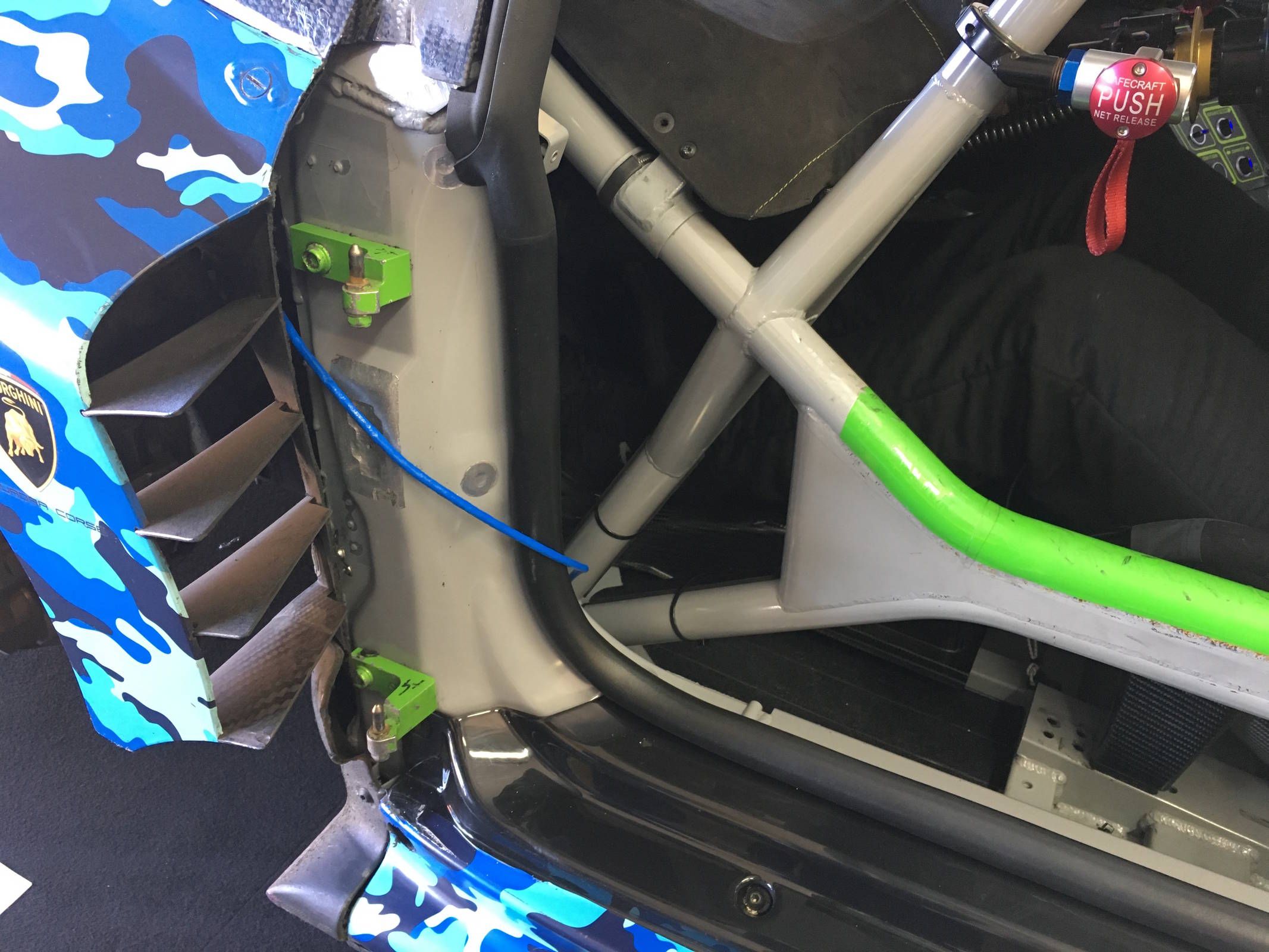 Instead of being bolted on, the Lamborghini Huracan GT3 Evo's doors easily lift off of these pins for easy access to the cabin.