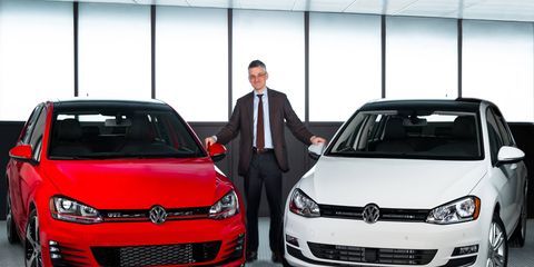 VW Group of America CEO Michael Horn poses with the 2015 Volkswagen Golf and Golf GTI models.