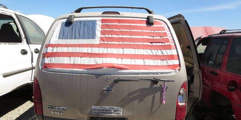 The van was worn out and not worth the expense of a new rear glass, so the final owner applied some tape and ingenuity.