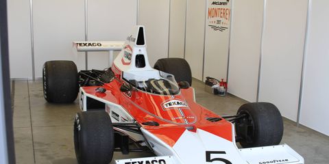 Mika Hakkinen climbs into the McLaren M23 once driven by Emerson Fittipaldi to win the 1974 Formula One Driver's World Championship