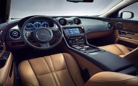 The interior of the 2015 Jaguar XJL Portfolio is still a British feast filled with leather and wood all around.