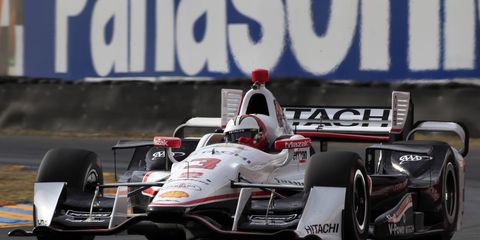 Helio Castroneves' favorite victory celebrations included climbing fences.
