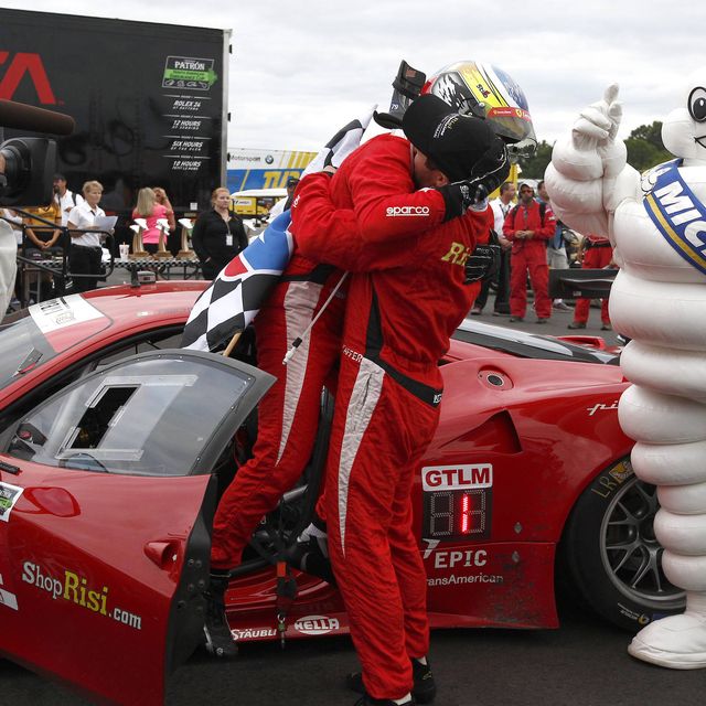 Giancarlo Fisichella and Pierre Kaffer embrace after winning the GTLM race in Virginia.