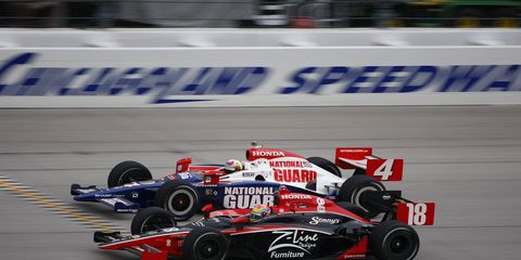 Dan Wheldon and Justin Wilson battle on the track in 2009.