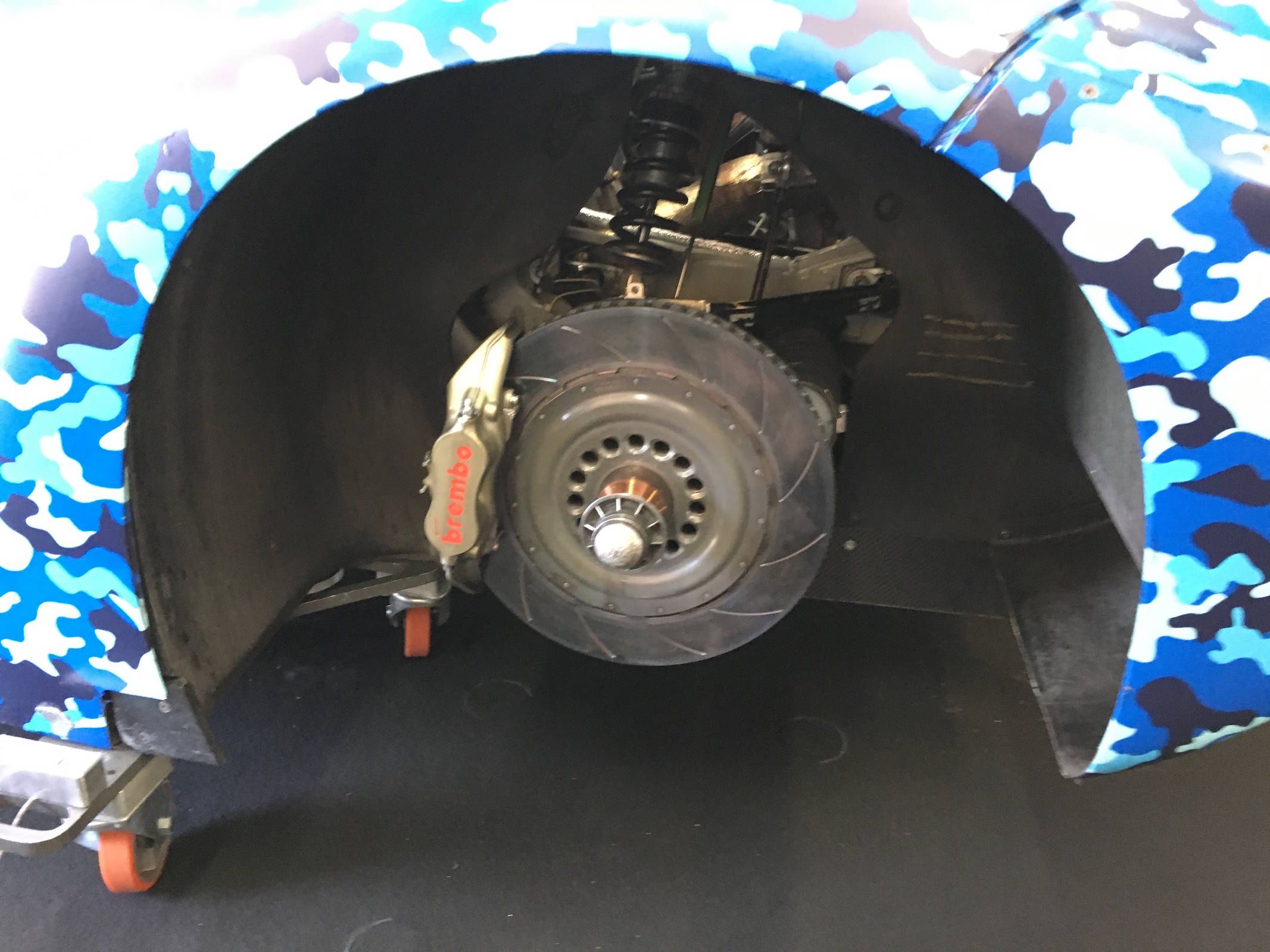 The slotted rotor is pretty darn big in back too, and the Brembo calipers have four pistons.