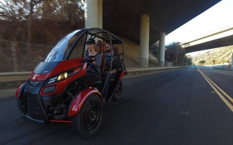 The Arcimoto SRK is a two-seat, three-wheeled electric car that will go 70 or 130 miles on a charge with a base price of $11,900. Plans call for it to be out by the end of the year.