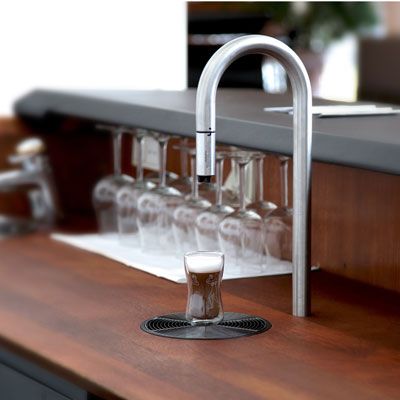 <p>Incredibly elegant, the Top Brewer is designed to look like a simple faucet, but dispenses much more than water. The stainless steel appliance can be built into any tabletop or countertop, and the end of the tap even contains a small milk frother, so a gourmet cup of coffee or shot of espresso can easily be made all at once, using no other bulky gadgets. This distinctively designed brewer is also tablet and smartphone compatible, meaning you can program your perfect brew directly from your favorite device.</p>
<p><a href="http://www.scanomat.com/coffee-brewers/topbrewer" target="_blank">scanomat.com</a></p>