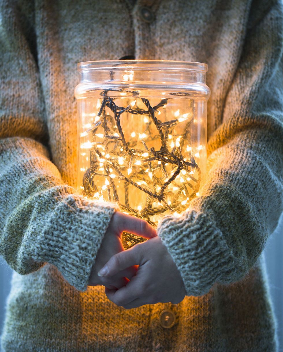 Woman with christmas lights in a jar
