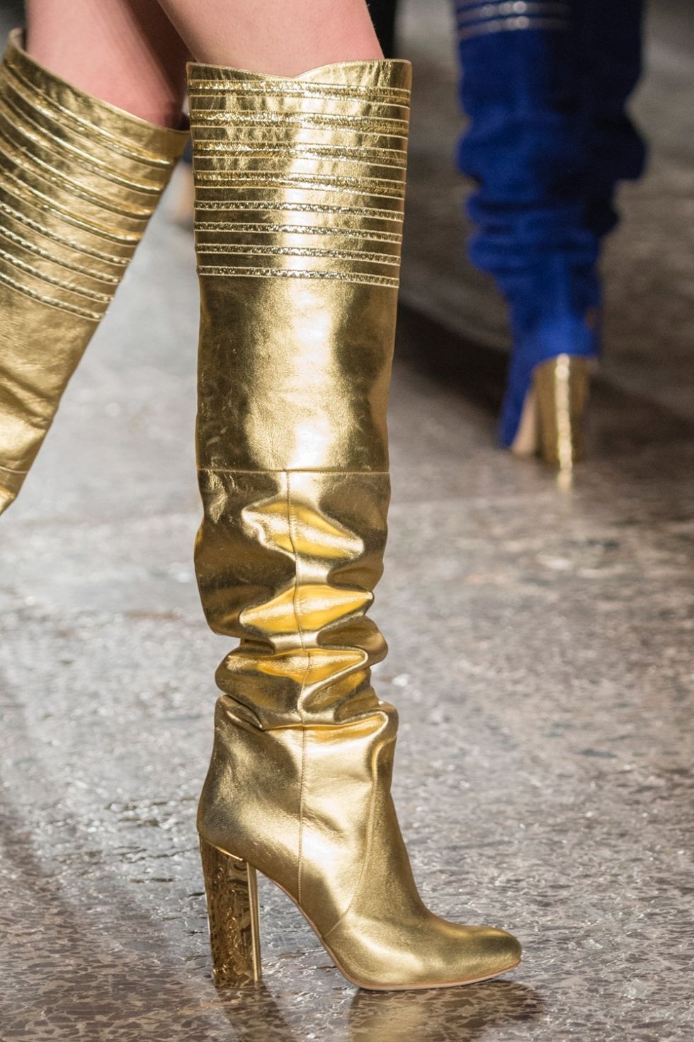 Human leg, High heels, Metal, Brass, Sandal, Boot, Costume accessory, Bronze, Foot, Leather, 