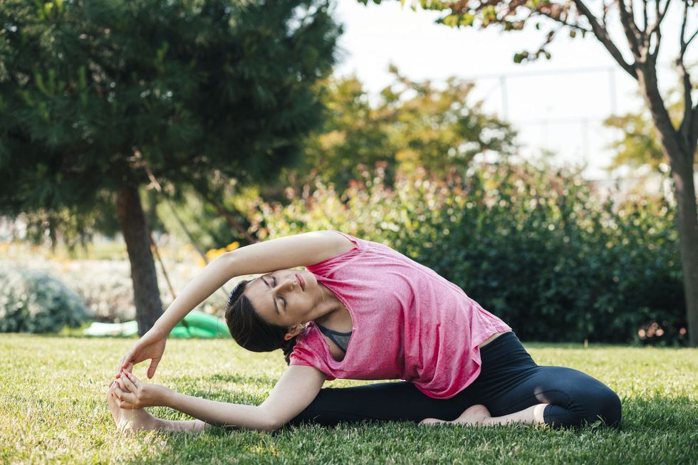 Young woman doing yoga in the park