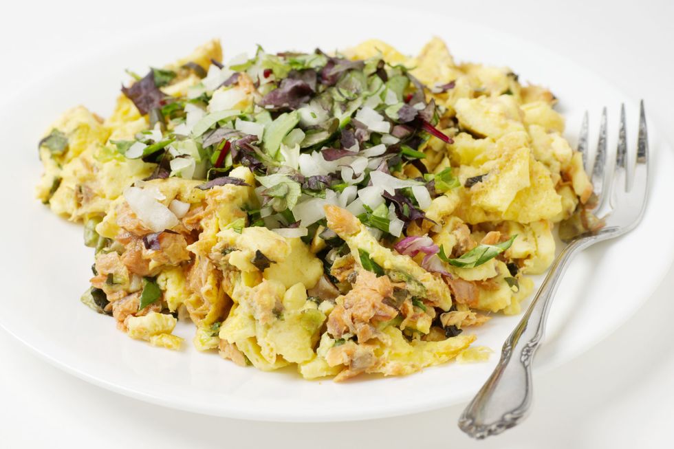 Scrambled eggs with salmon, onions, and herbs