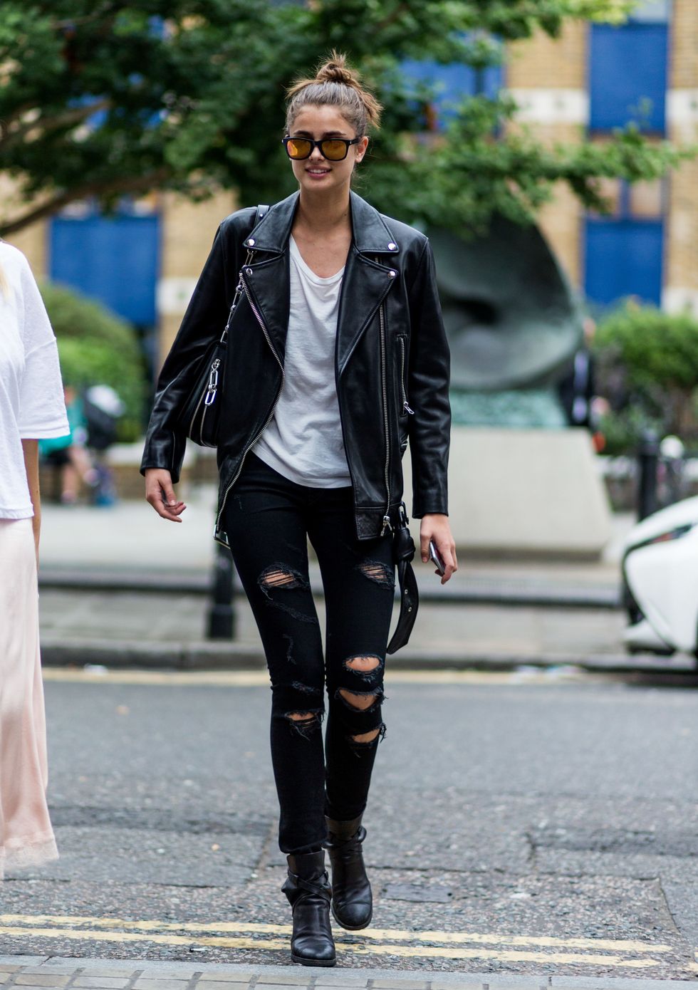LONDON, ENGLAND - SEPTEMBER 18: Model Taylor Hill wearing black leather jacket and ripped black jeans outside Topshop during London Fashion Week Spring/Summer collections 2017 on September 18, 2016 in London, United Kingdom. (Photo by Christian Vierig/Getty Images)