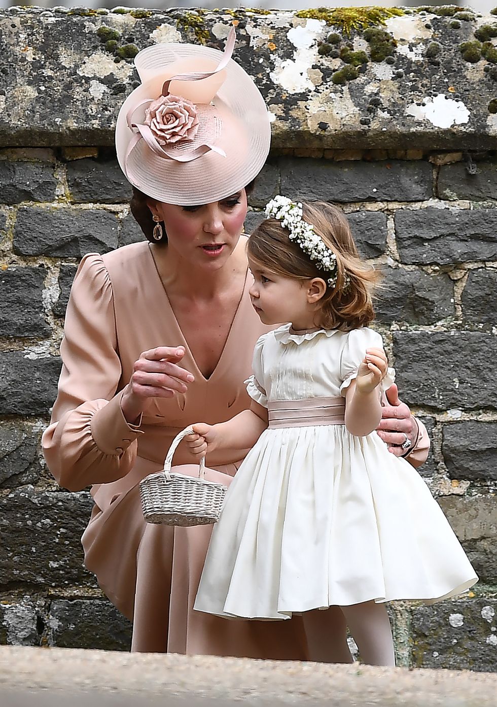 ENGLEFIELD GREEN, ENGLAND - MAY 20:  Catherine, Duchess of Cambridge stands with her daughter Princess Charlotte of Cambridge, a bridesmaid, following the wedding of her sister Pippa Middleton to James Matthews at St Mark's Church on May 20, 2017 in Englefield Green, England.  (Photo by Justin Tallis - WPA Pool)