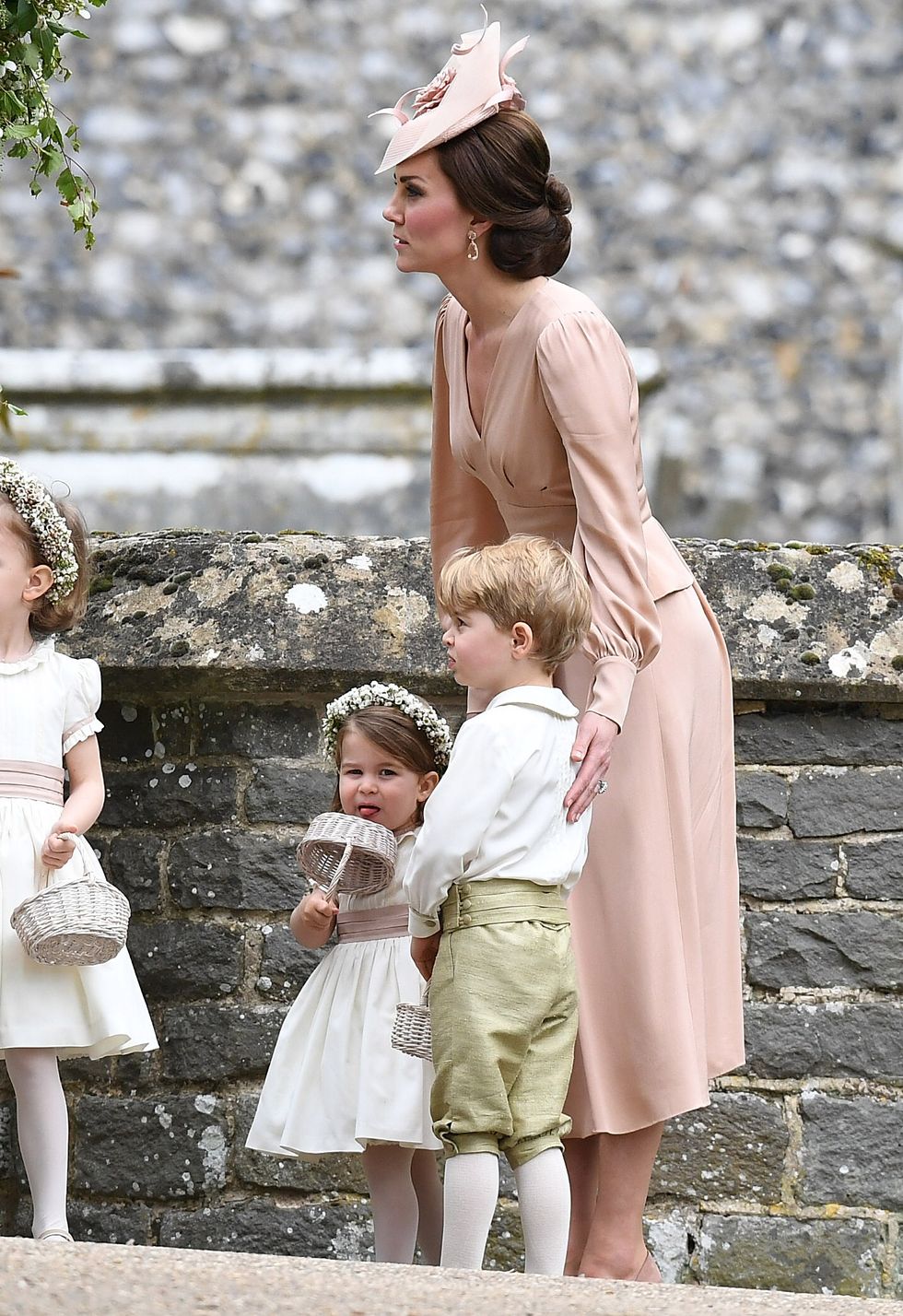 ENGLEFIELD GREEN, ENGLAND - MAY 20:  Catherine, Duchess of Cambridge, with  Prince George of Cambridge (R), page boy and Princess Charlotte of Cambridge (R), bridesmaid, after the wedding of Pippa Middleton and James Matthews at St Mark's Church on May 20, 2017 in Englefield Green, England.  (Photo by Samir Hussein/Samir Hussein/WireImage)