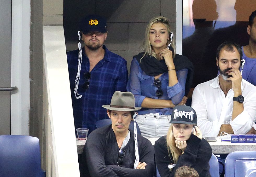 NEW YORK, NY - SEPTEMBER 13: Leonardo DiCaprio, Kelly Rohrbach and Lukas  attend the Men's Final on day fourteen of the 2015 US Open at USTA Billie Jean King National Tennis Center on September 13, 2015 in the Flushing neighborhood of the Queens borough of New York City. (Photo by Jean Catuffe/GC Images)