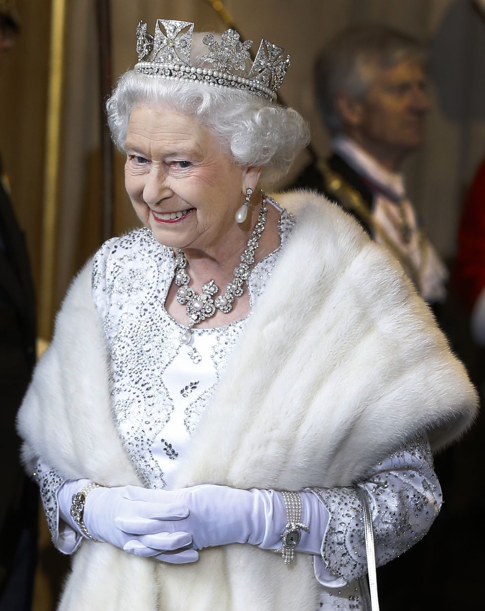LONDON, ENGLAND - MAY 08:  Queen Elizabeth II smiles as she leaves the State Opening of Parliament at the House of Lords on May 8, 2013 in London, England. Queen Elizabeth II unveils the coalition government's legislative programme in a speech delivered to Members of Parliament and Peers in The House of Lords. Proposed legislation is expected to be introduced on toughening immigration regulations, capping social care costs in England and setting a single state pension rate of 144 GBP per week.  (Photo by Kirsty Wigglesworth - WPA Pool/Getty Images)