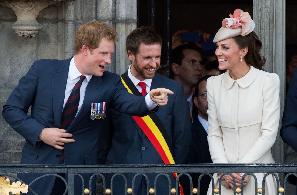MONS, BELGIUM - AUGUST 04:  Prince Harry makes a joke as Catherine, Duchess of Cambridge looks on from the balcony of the town hall as they attend a reception at the Grand Place on August 4, 2014 in Mons, Belgium. Monday 4th August marks the 100th Anniversary of Great Britain declaring war on Germany. In 1914 British Prime Minister Herbert Asquith announced at 11pm that Britain was to enter the war after Germany had violated Belgium's neutrality. The First World War or the Great War lasted until 11 November 1918 and is recognised as one of the deadliest historical conflicts with millions of casualties. A series of events commemorating the 100th Anniversary are taking place throughout the day.  (Photo by Samir Hussein/WireImage)