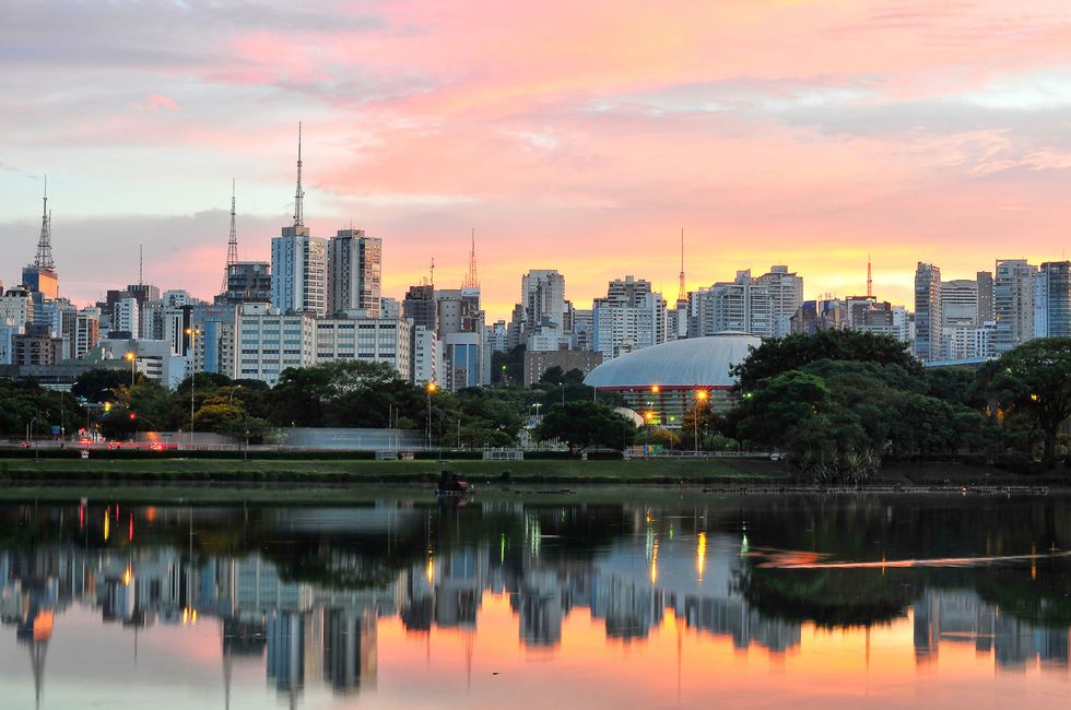 Skyline with reflections on lake at sunrise, Ibirapuera Park, S?o Paulo, Brazil.