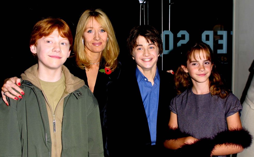 LONDON - NOVEMBER 4:   Actors Rupert Grint, Author JK Rowling, Daniel Radcliffe and Emma Watson attend the world premiere of the first Harry Potter film, 'Harry Potter and the Philosopher's Stone' at the Odeon Leicester Square, London, November 4, 2001. (Photo by Gareth Davies/Getty Images)