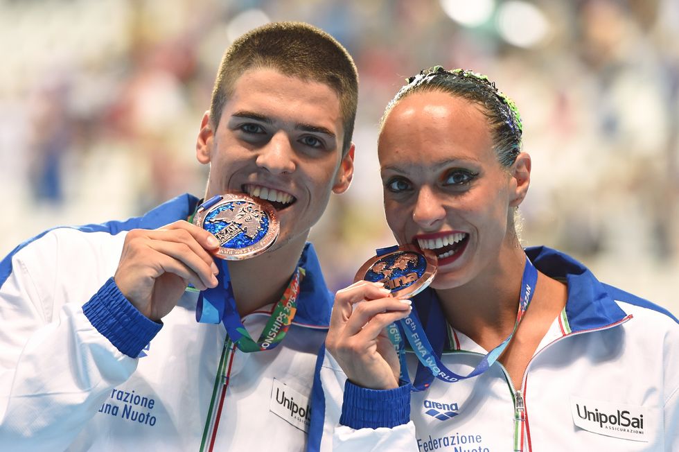 Italy's mixed duet Mariangela Perrupato and Giorgio Minisini poses with their bronze medal during the podium ceremony of the women's duet Free final event during the synchronised swimming competition at the 2015 FINA World Championships in Kazan on July 30, 2015.  AFP PHOTO / CHRISTOPHE SIMON        (Photo credit should read CHRISTOPHE SIMON/AFP/Getty Images)