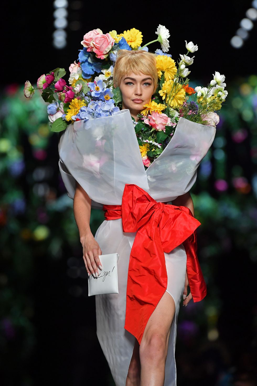 Model Gigi Hadid presents a creation for fashion house Moschino during the Women's Spring/Summer 2018 fashion shows in Milan, on September 21, 2017.  / AFP PHOTO / Marco BERTORELLO        (Photo credit should read MARCO BERTORELLO/AFP/Getty Images)