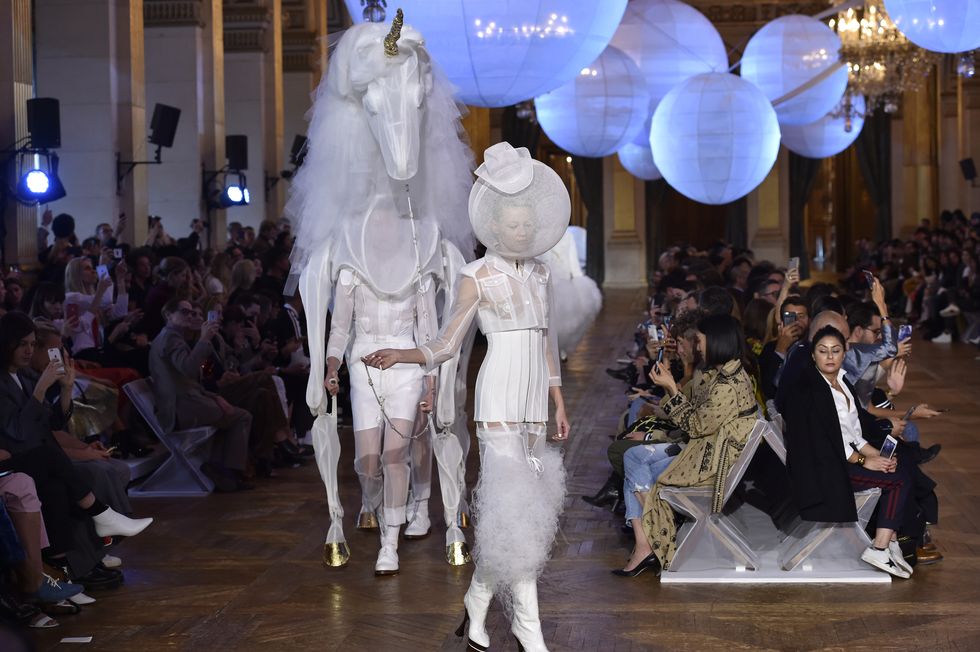 PARIS, FRANCE - OCTOBER 03:  Models walk the runway with unicorn puppet at the Thom Browne Spring Summer 2018 fashion show during Paris Fashion Week on October 3, 2017 in Paris, France.  (Photo by Catwalking/Getty Images)