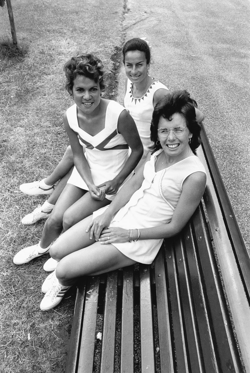 Billie Jean King, Yvonne Goolagong, and Virginia Wade, seated on a bench at the Wimbledon tennis club. (Photo by © Hulton-Deutsch Collection/CORBIS/Corbis via Getty Images)