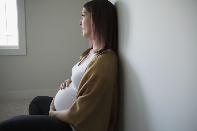 a pregnant woman sitting down