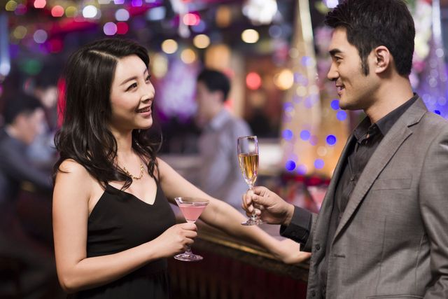 Attractive young couple drinking champagne in bar
