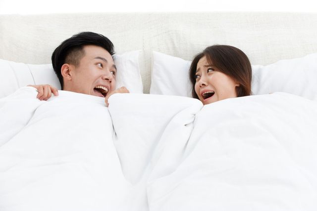 couple surprising in the bed