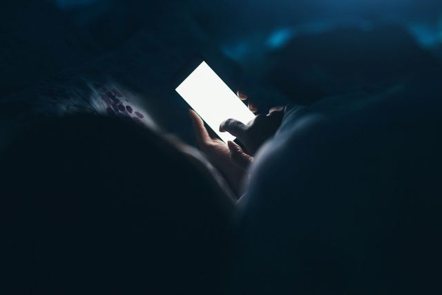 woman using phone in a dark