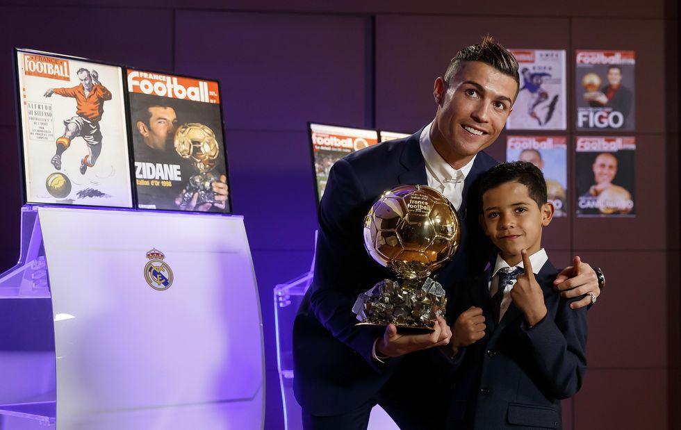 MADRID, SPAIN - DECEMBER 12:  Cristiano Ronaldo (L) of Real Madrid and his son Cristiano Ronaldo Jr. pose with the Ballon D'Or 2016 trophy at Estadio Santiago Bernabeu on December 12, 2016 in Madrid, Spain.  (Photo by Angel Martinez/Real Madrid via Getty Images)