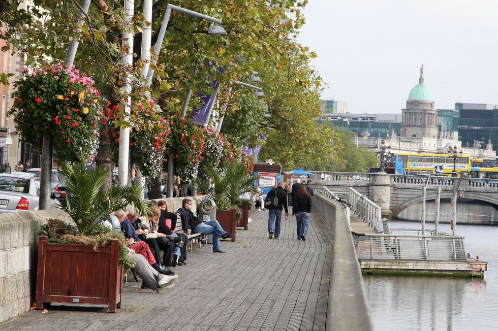 DUBLIN, IRELAND - OCTOBER 15: People relax on the river front on October 15, 2009 in Dublin, Ireland. Dublin is Ireland's capital city, located near the midpoint of Ireland's east coast, on the River Liffey. It is a vibrant city with a thriving music scene and has been voted one of the top 25 cities of the world to live in. Irish President Mary McAleese signed the European Union's Lisbon treaty today, two weeks after voters approved the Lisbon Treaty in a controversial referendum.  (Photo by Chris Jackson/Getty Images)