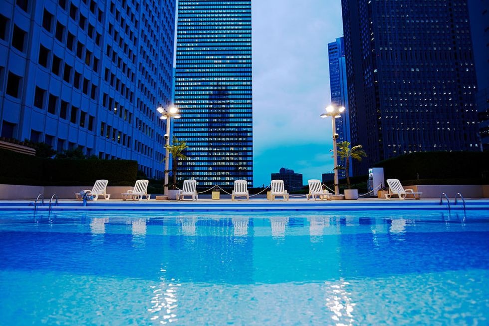 Blue, Building, Swimming pool, Metropolitan area, Condominium, City, Architecture, Skyscraper, Sky, Human settlement, 