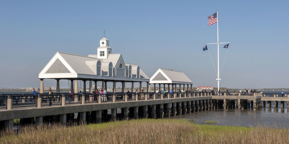 Pier, Boardwalk, Walkway, Architecture, Coast, Nonbuilding structure, Flag, House, Building, Tourist attraction, 