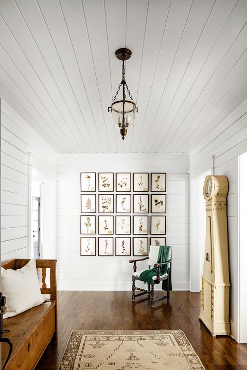 neutral entryway with shiplap walls and ceiling