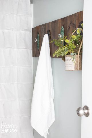 Wall, Towel, Door handle, Household hardware, Handle, Linens, Dead bolt, Houseplant, Silver, Flowerpot, 