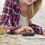 woman paying bills household expenses money save