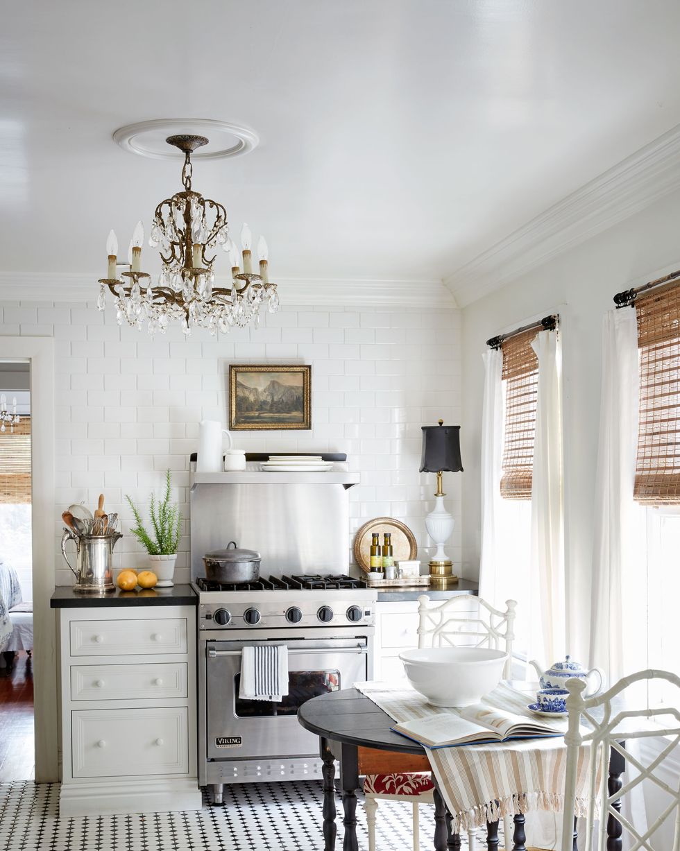 white cottage kitchen with gateleg dining table and chandelier