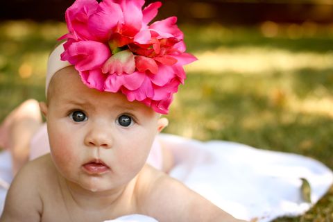 Skin, Petal, Pink, Flower, Hair accessory, Child, People in nature, Headgear, Fashion accessory, Headpiece, 